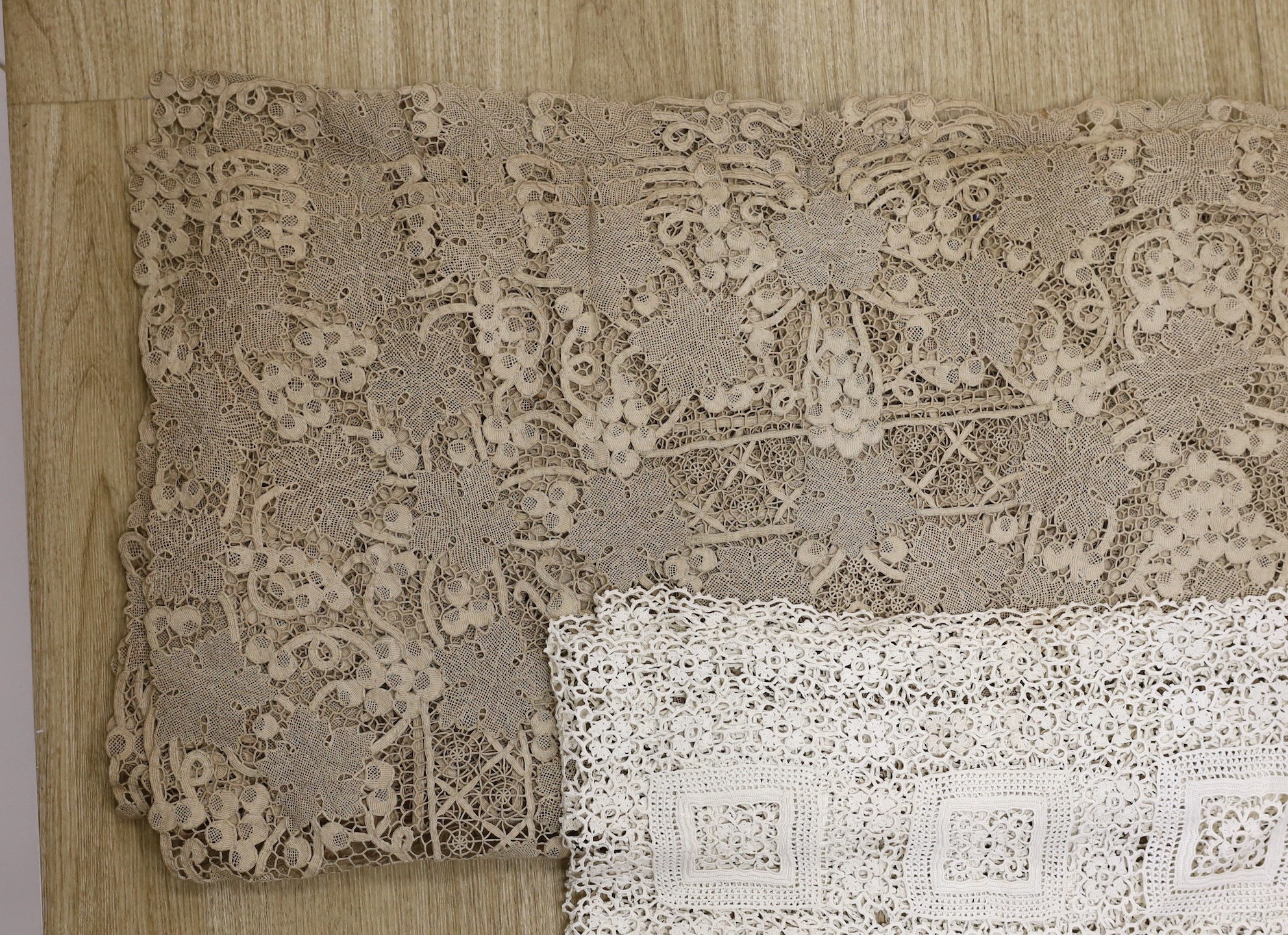 An large ecru continental hand worked table cloth and smaller linen cloth with a deep crochet edge, large cloth 232cms long x 186cms wide